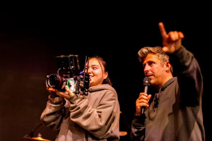 Directing a student behind a cinema camera