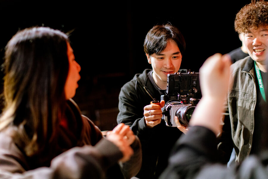 A student filming an interview setup