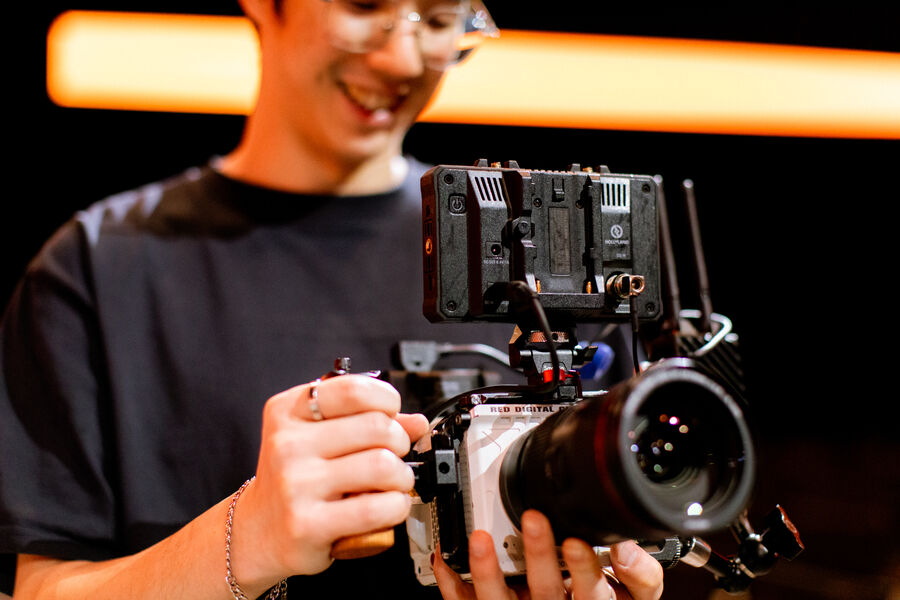 A student rigging a cinema camera